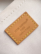 Louis Vuitton leather label patch with stitched border on white textured fabric