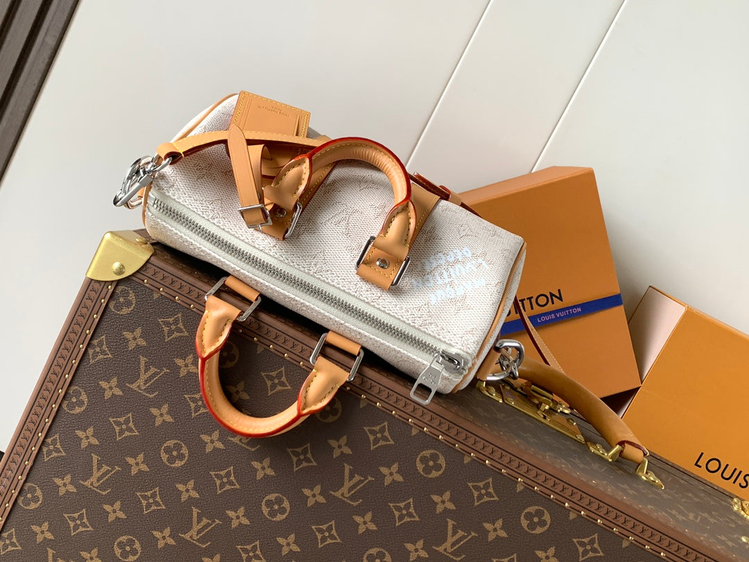 Louis Vuitton small handbag with white monogram canvas, tan strap and silver zipper