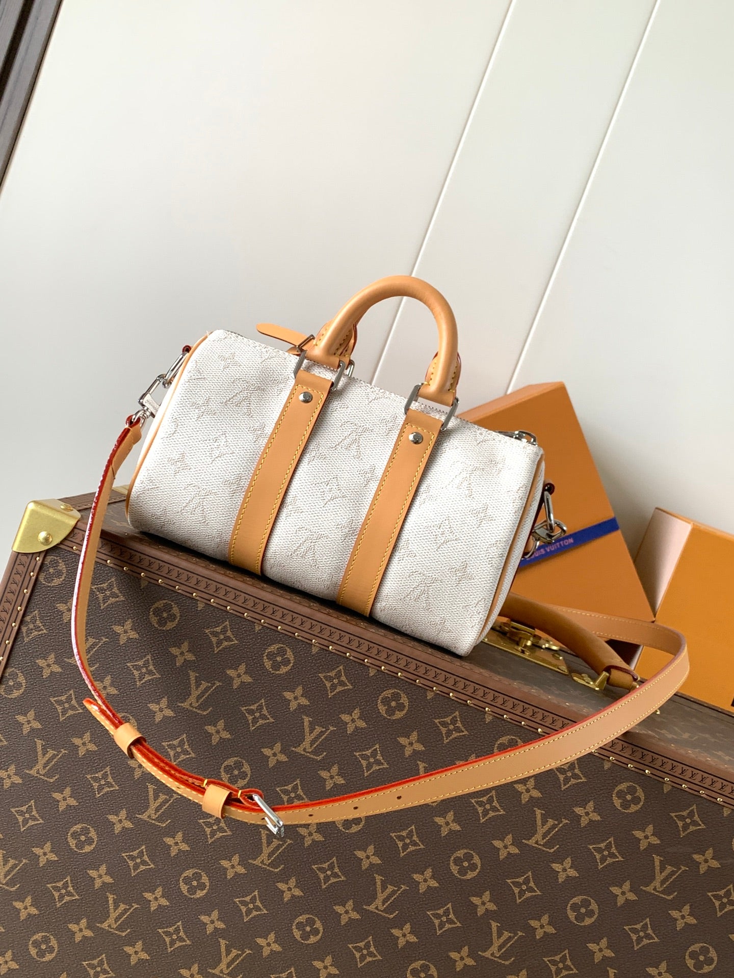Louis Vuitton handbag with white monogram canvas, tan leather handles and crossbody strap