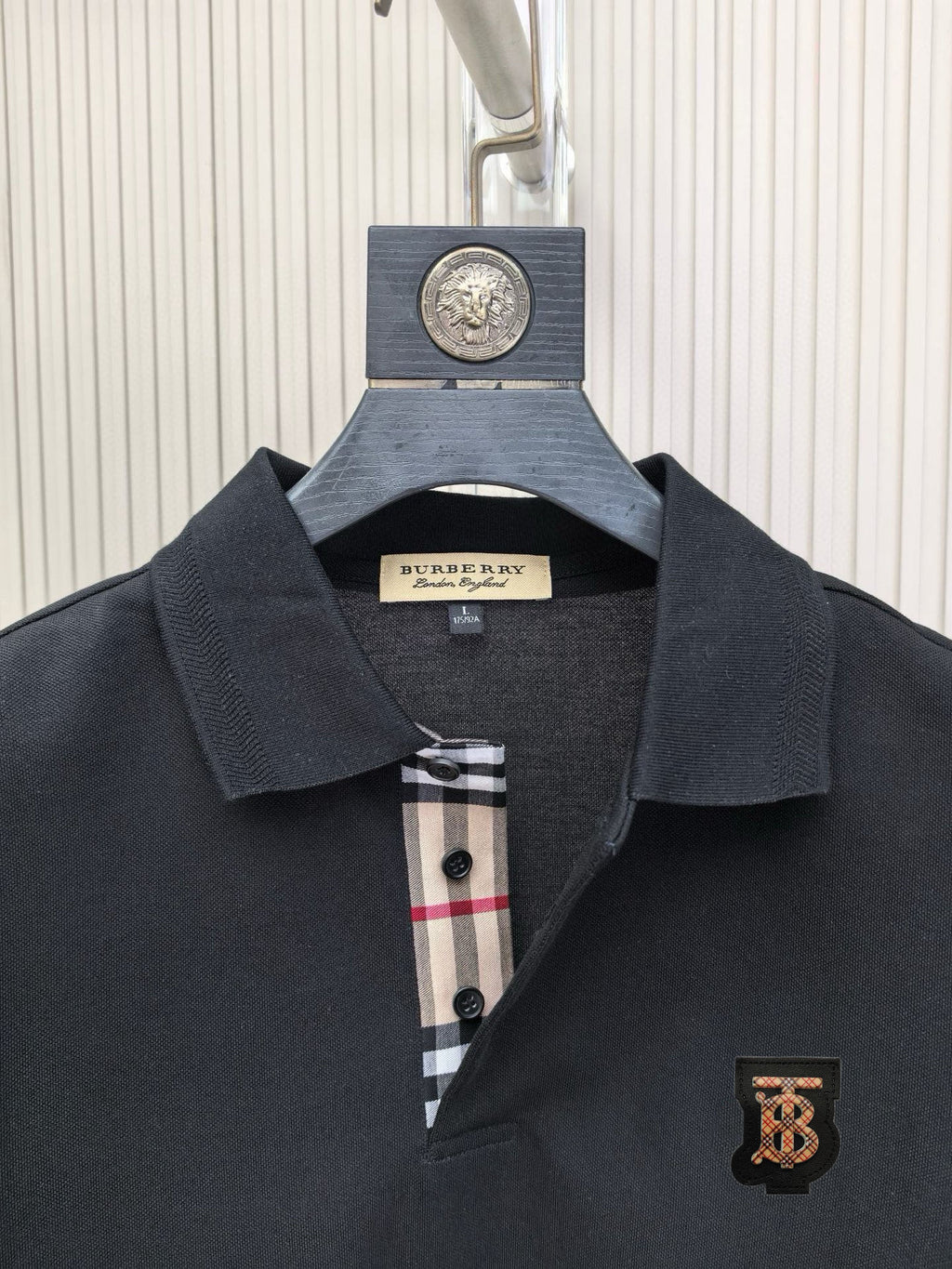 Dark polo shirt collar with button placket and Burberry crest patch