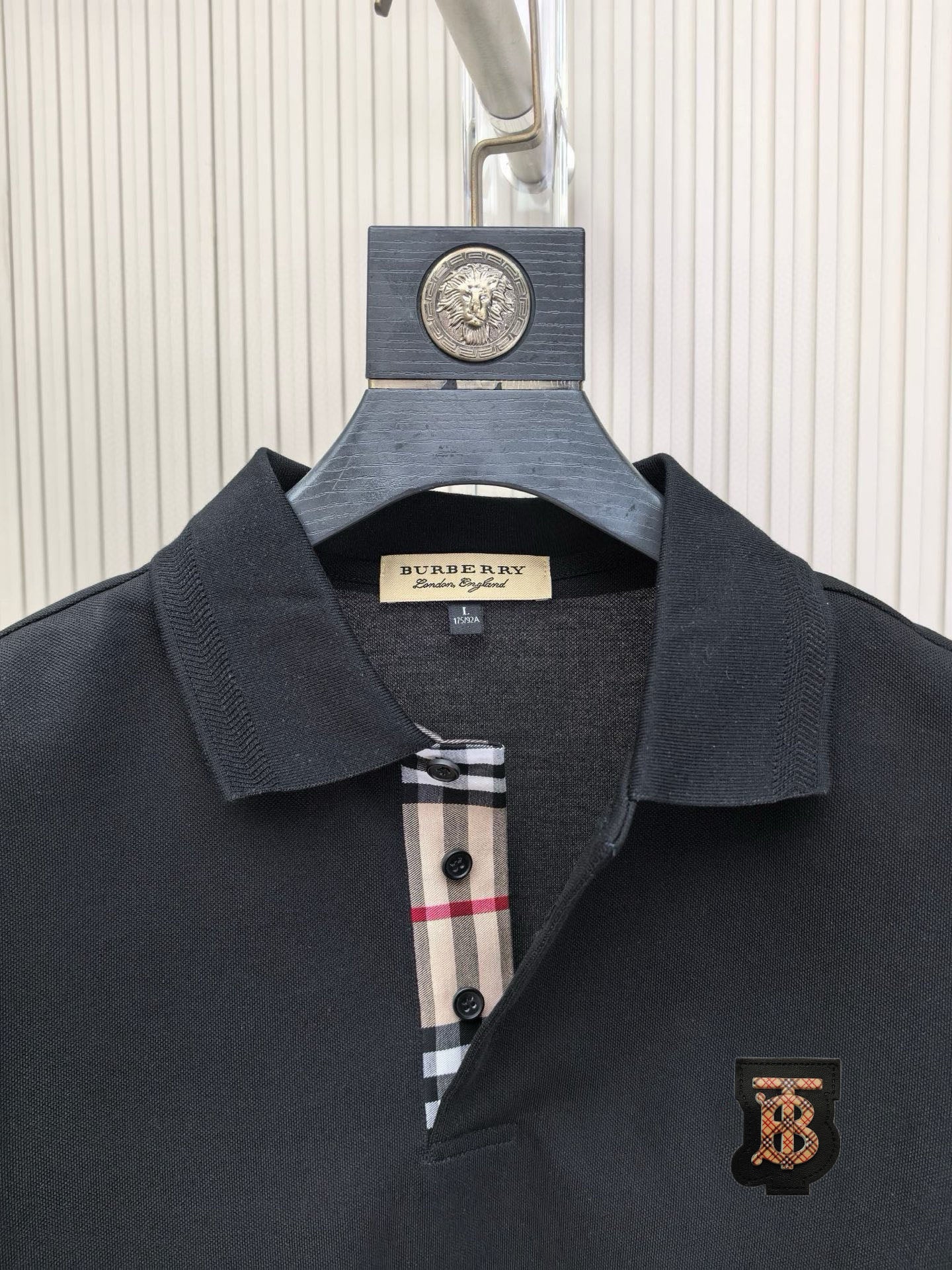 Dark polo shirt collar with button placket and Burberry crest patch