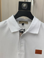 White polo shirt collar and button placket with logo patch