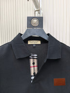 Dark polo shirt collar with button placket and check inner trim, logo patch