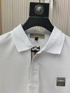 White polo shirt collar and button placket with Burberry logo patch