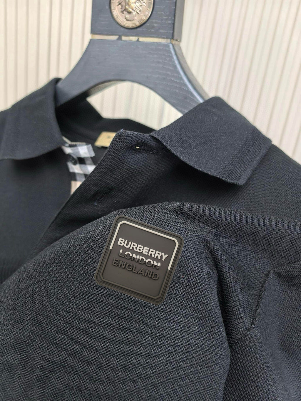 Burberry polo shirt logo patch on dark navy chest with check-trim placket