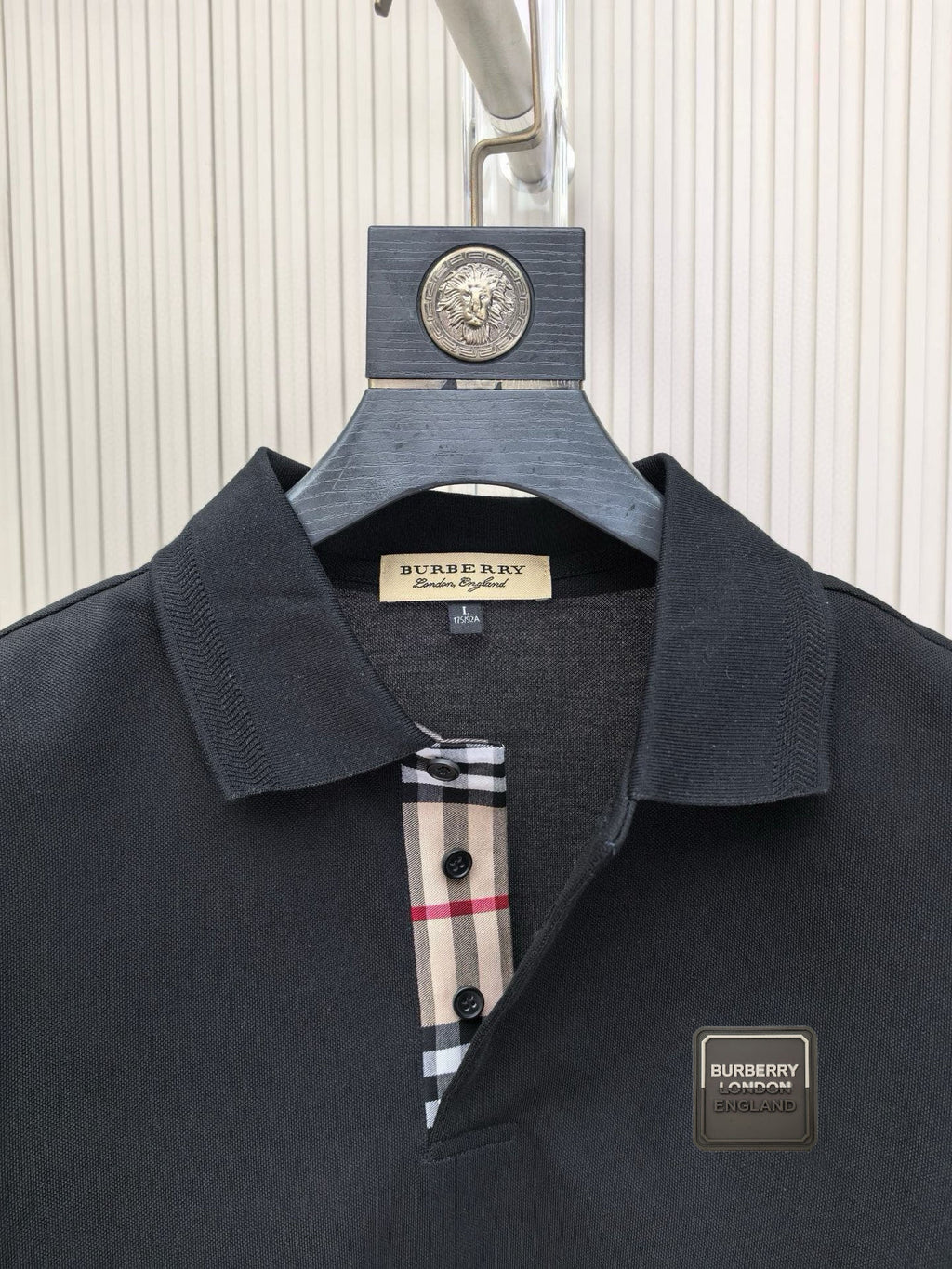 Burberry polo shirt, dark navy collar with check-trim placket and logo patch