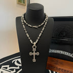 Silver-toned beaded chain cross pendant necklace, close view on bust
