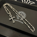Silver-toned beaded chain cross pendant necklace set on black gift box