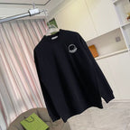 Black long-sleeve sweatshirt with small Moncler logo emblem near left chest