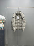 Light gray Moncler puffer jacket with hood and front zipper, hanging on display