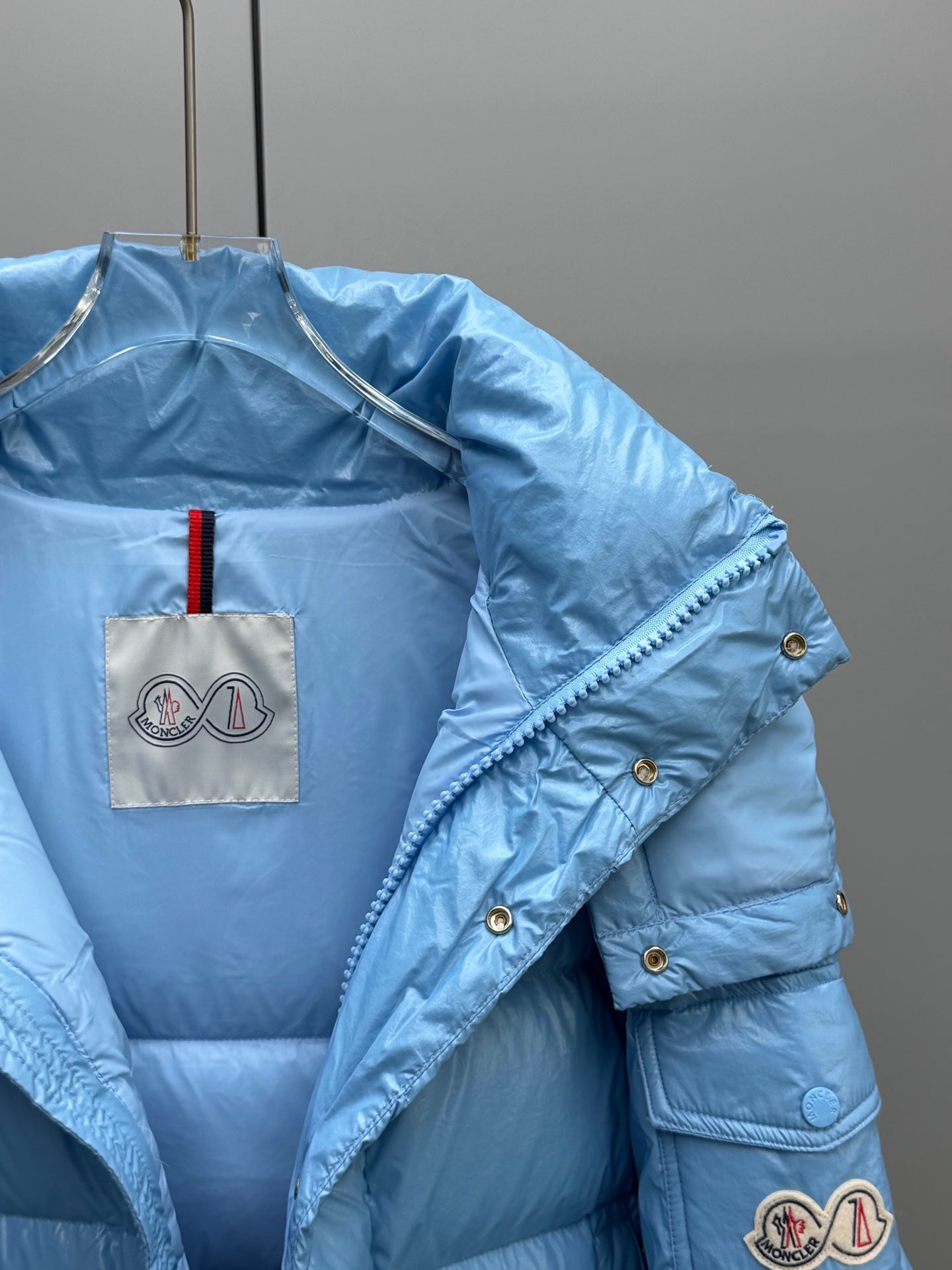 Moncler hooded puffer jacket, light blue, angled detail with logo patch