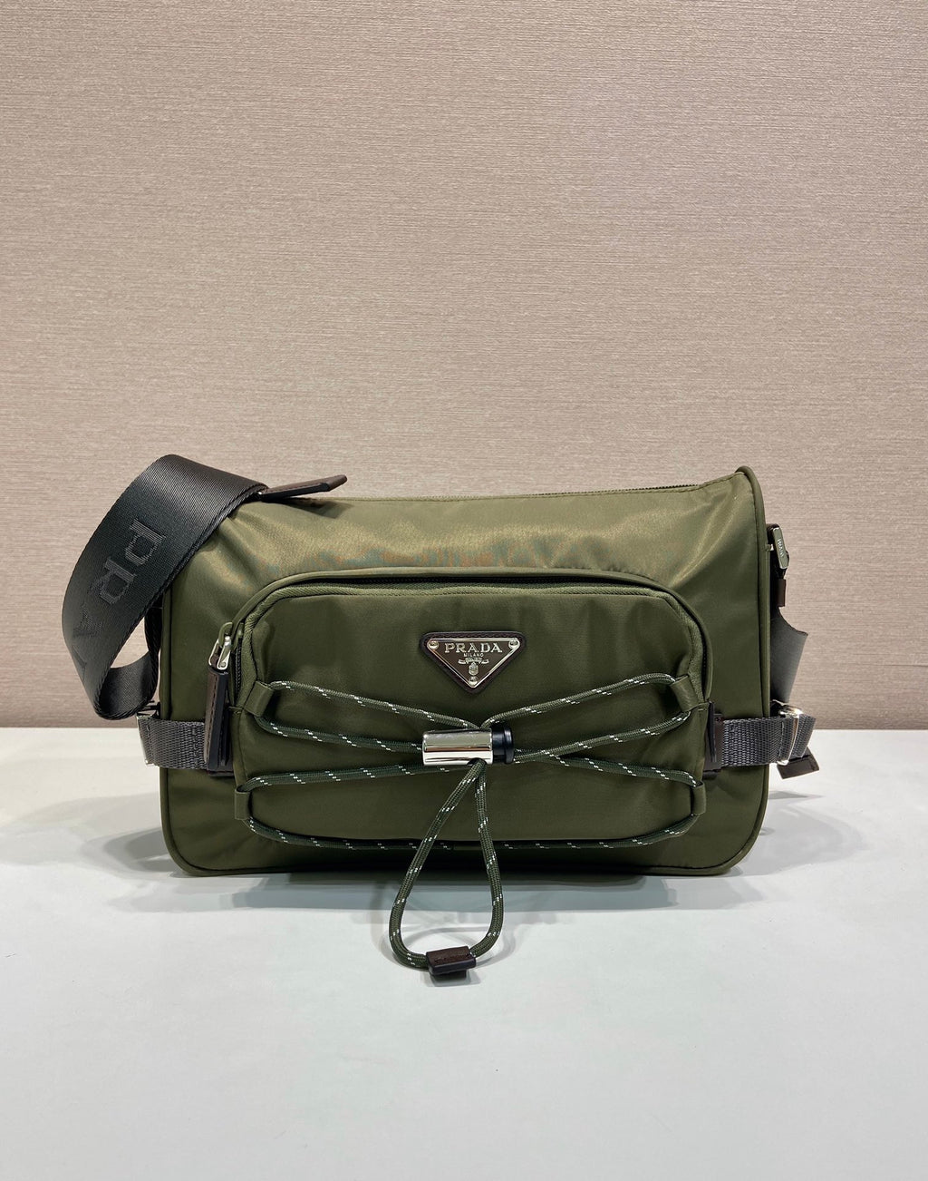 Olive Prada crossbody bag with flap, quilted front panel, and adjustable shoulder strap