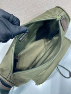 Olive Prada bag with open top zipper and fabric-lined interior
