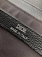 Black Dior leather label reading “DIOR” and “MADE IN ITALY” on edge seam.