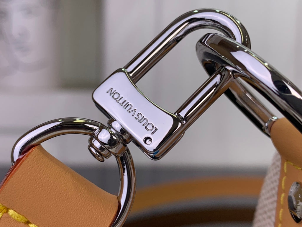 Louis Vuitton bag hardware clasp and rings on tan strap