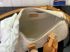 Men's Louis Vuitton duffel bag interior view with zipper opening and beige lining