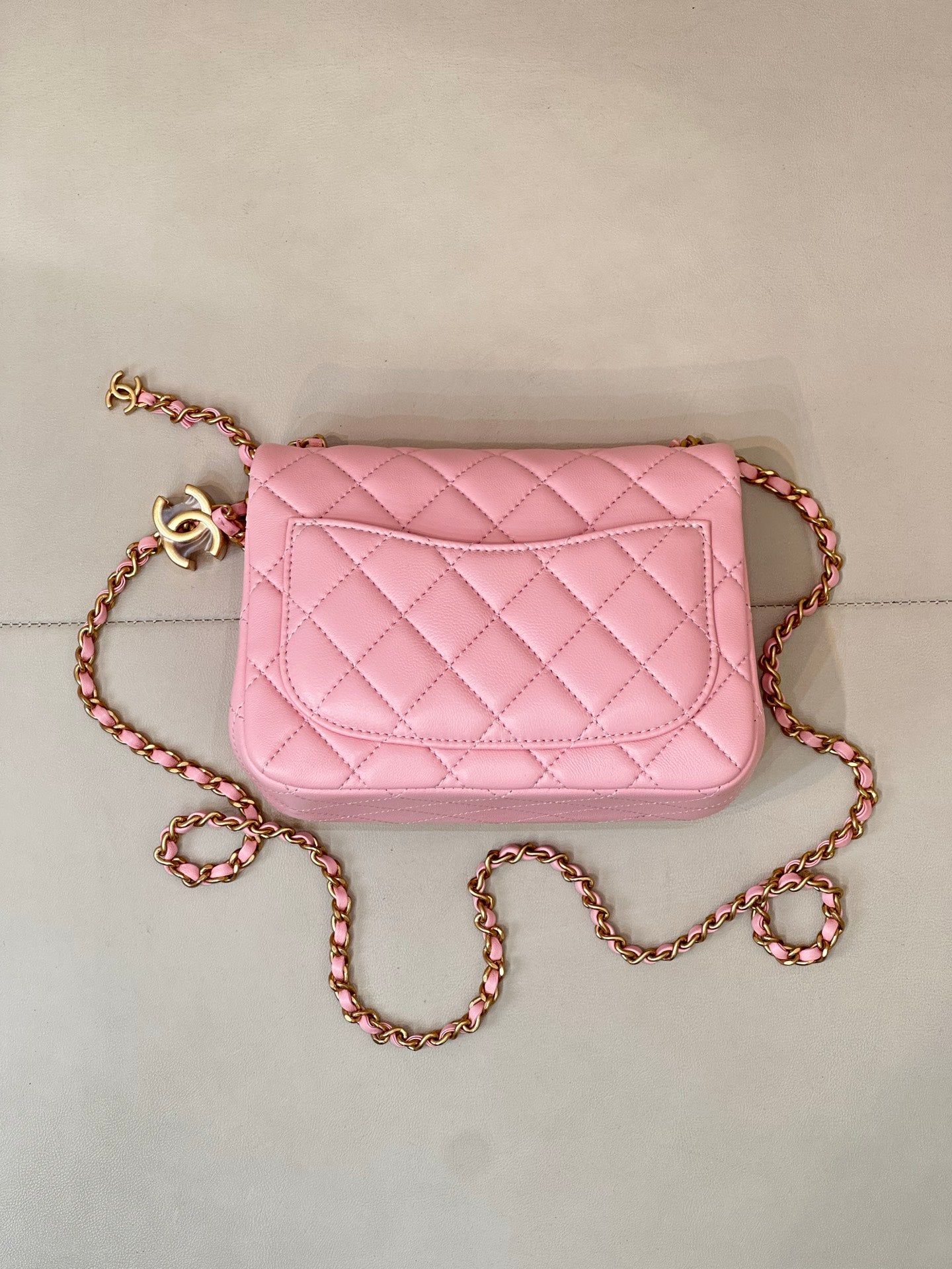 Pink quilted Chanel flap crossbody bag with gold-tone logo and chain strap