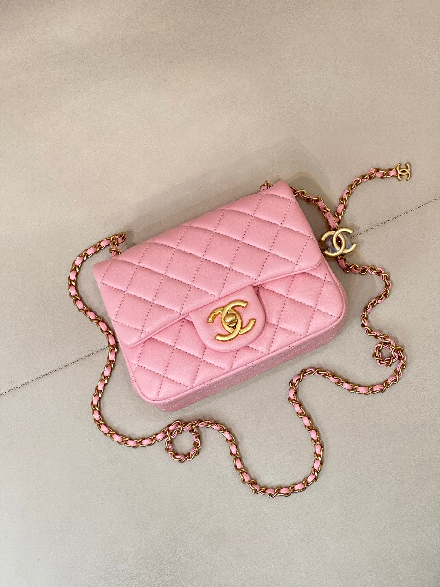 Pink quilted Chanel flap crossbody bag with gold-tone logo and chain strap