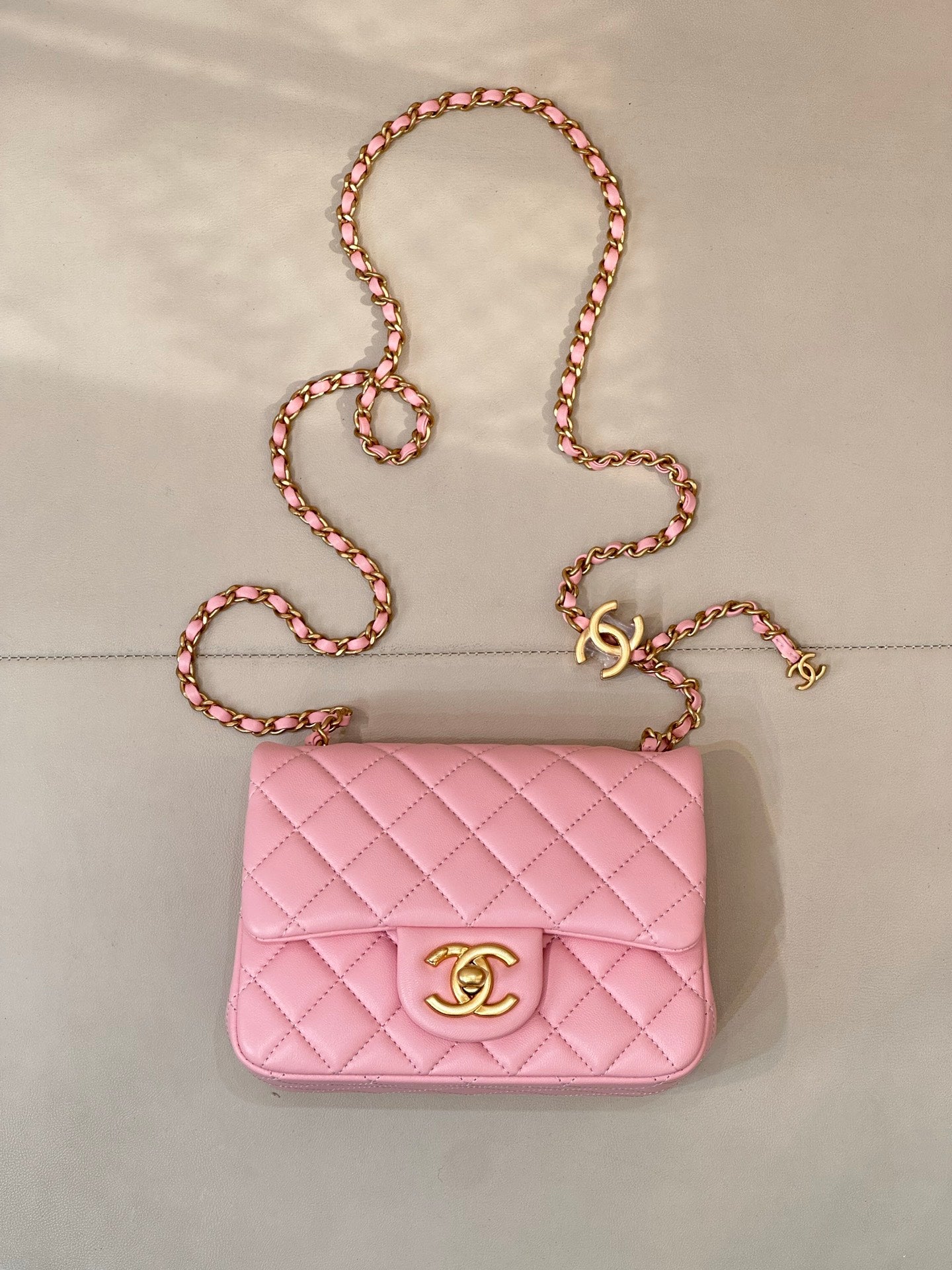 Pink quilted Chanel flap crossbody bag with gold-tone logo and chain strap