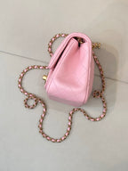 Pink quilted Chanel mini shoulder bag with gold-tone chain and side profile