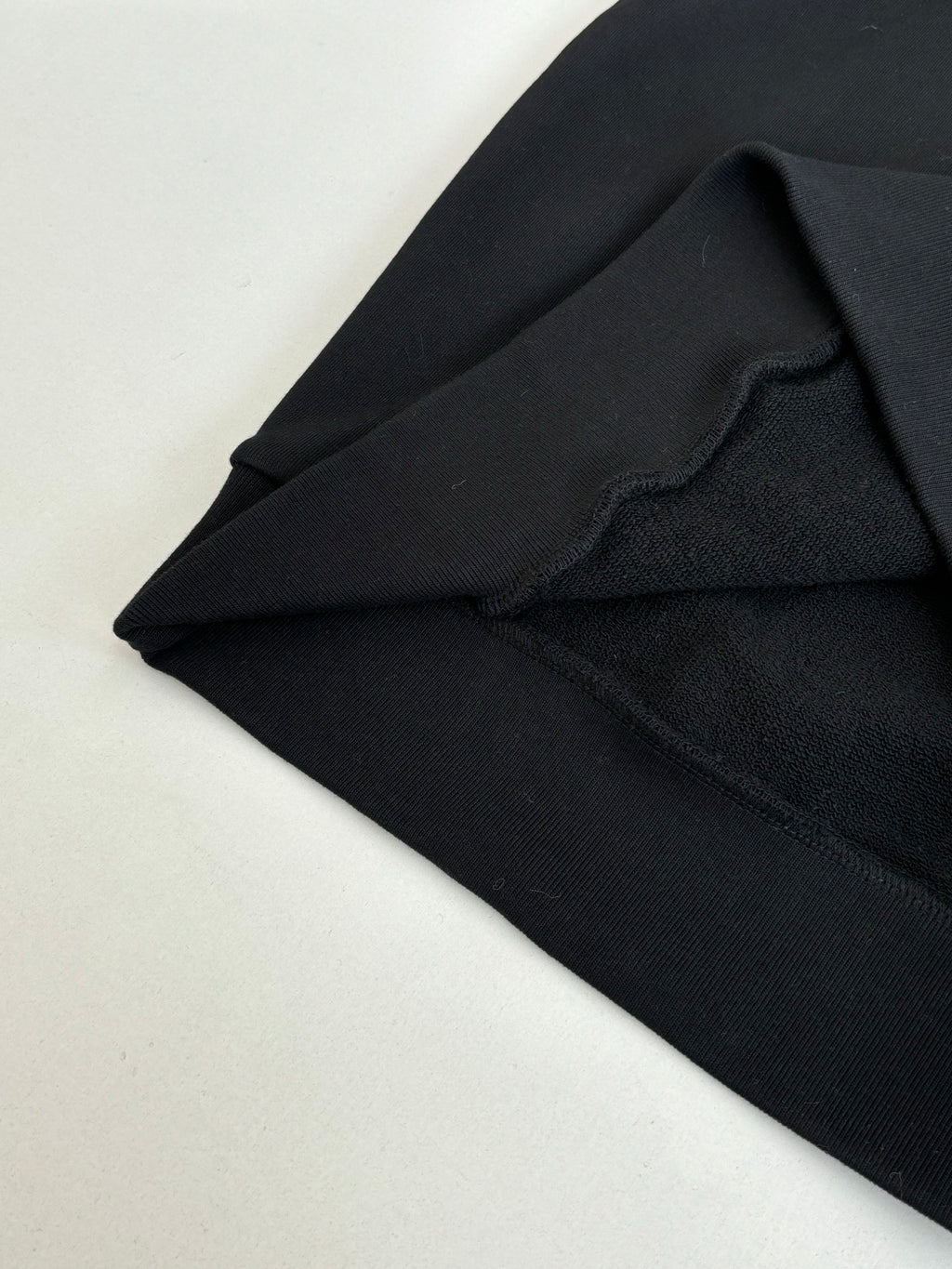Black Louis Vuitton hooded sweatshirt fabric and seam detail near shoulder