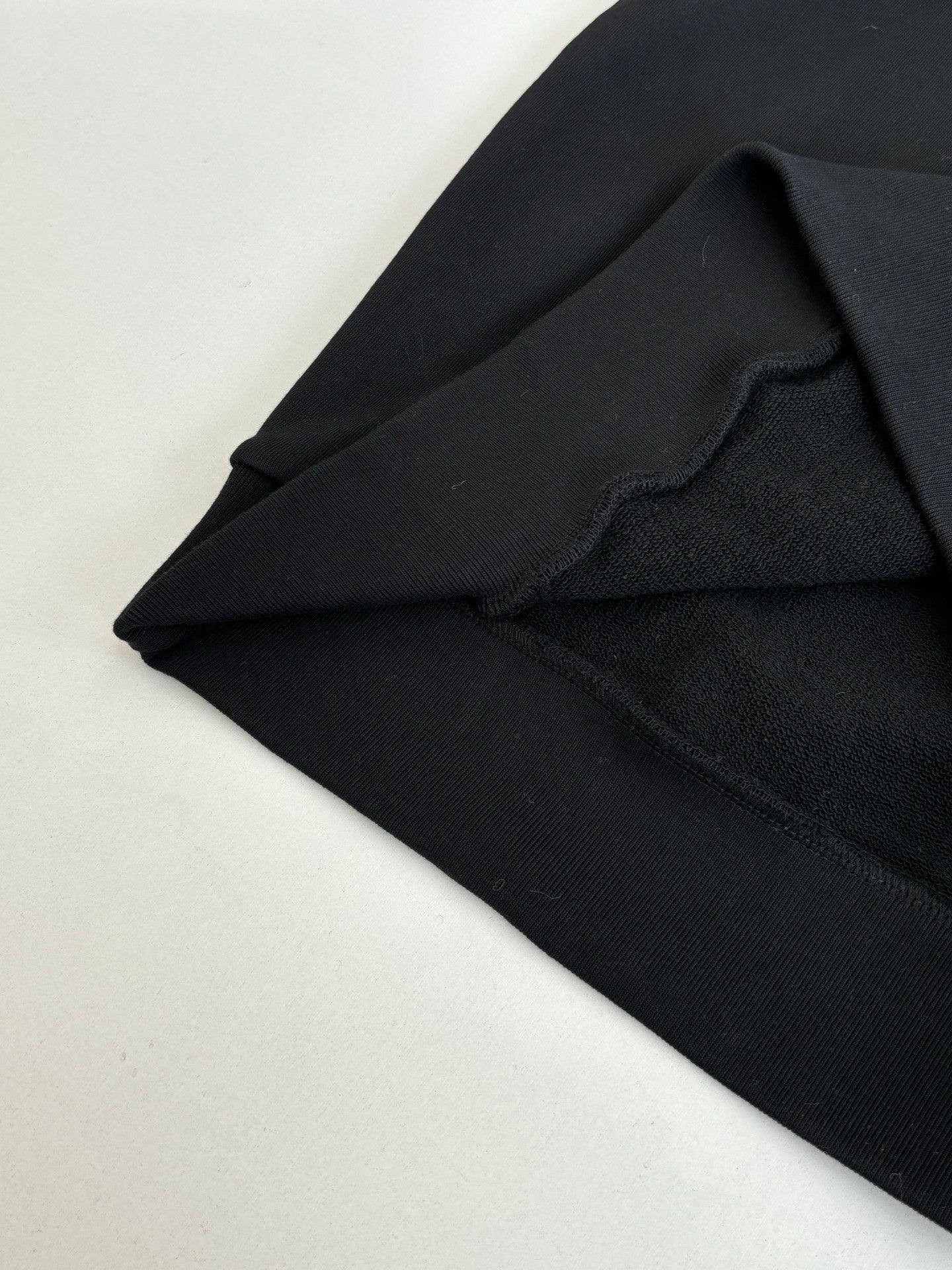 Black Louis Vuitton hooded sweatshirt fabric and seam detail near shoulder