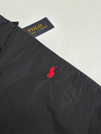 Red polo pony logo on black jacket chest area
