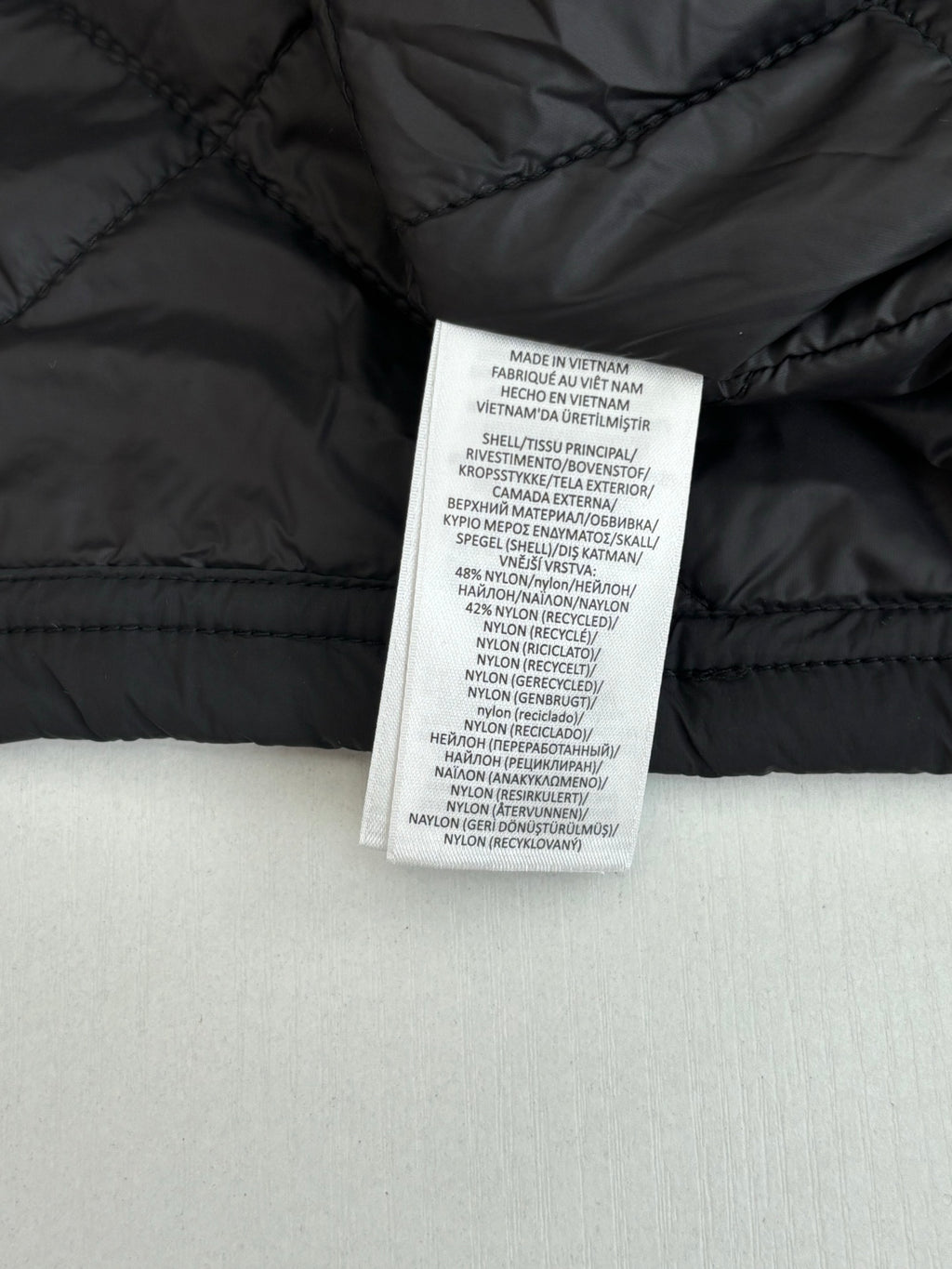 Black jacket interior care label stitched inside collar