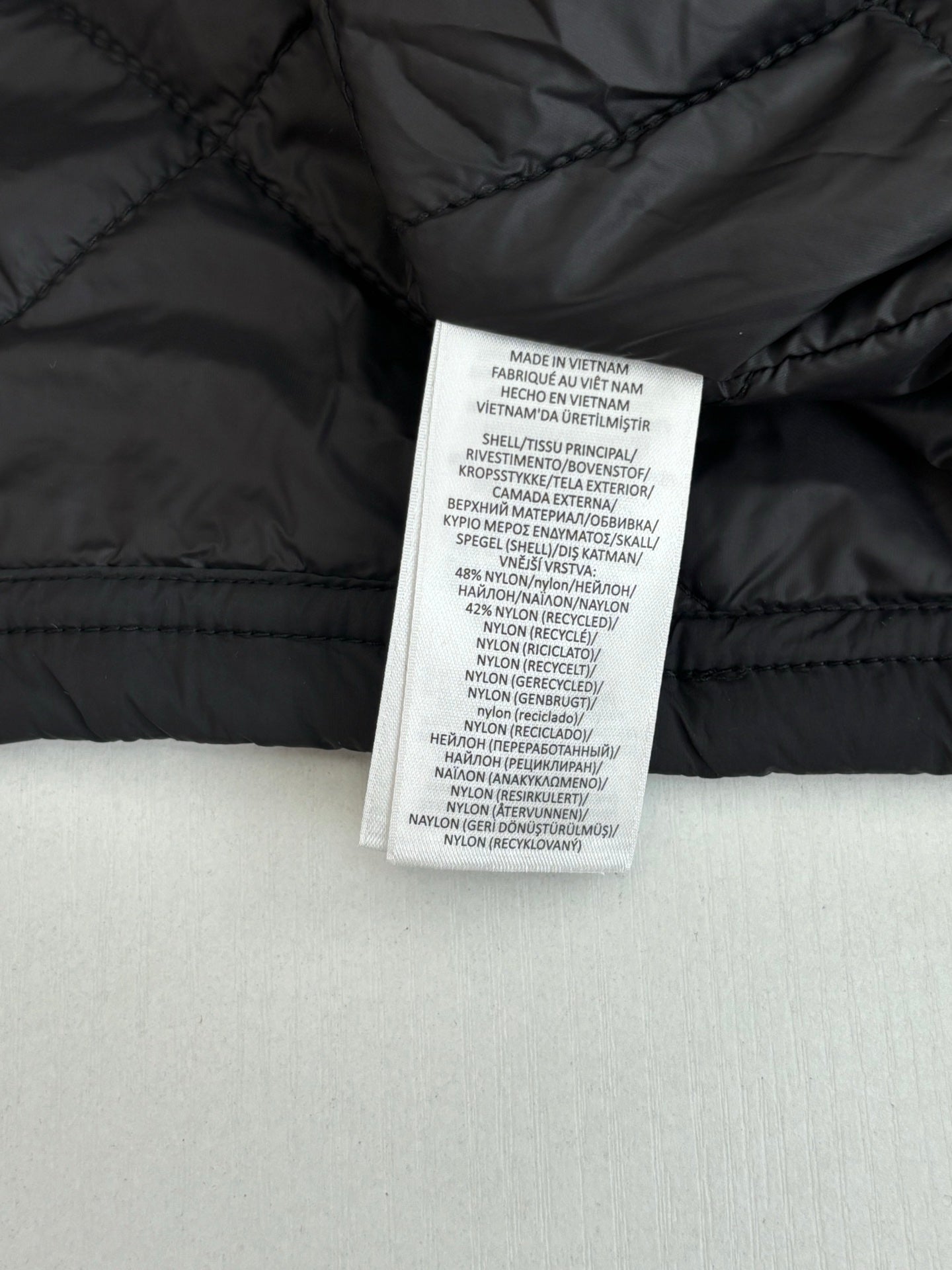 Black jacket interior care label stitched inside collar