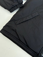 Black puffer jacket with elastic cuff and stitched seam details