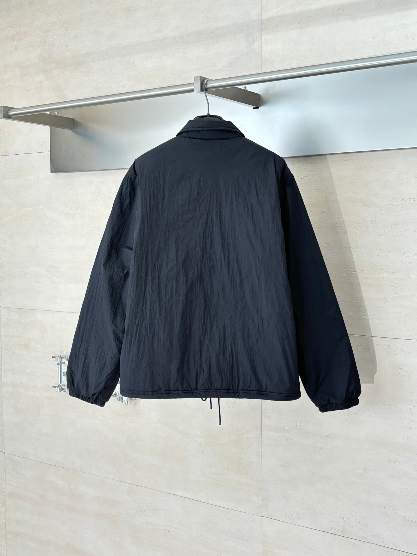Navy stand-collar jacket with elastic cuffs and drawstring hem