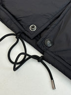 Black jacket with drawstring waist and metal snap/button details