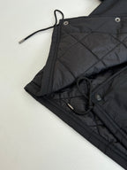 Black jacket with drawstring ties and metal button hardware