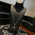 Silver chain necklace with square pendant on black display bust