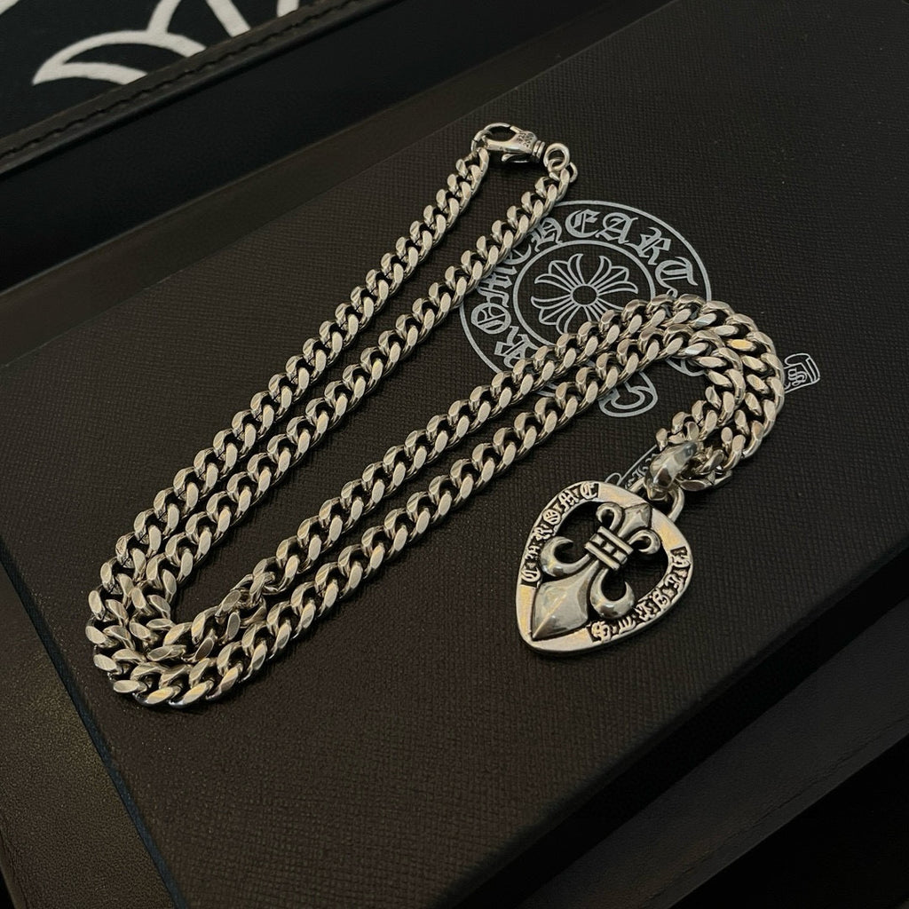 Silver-tone chain necklace with Chrome Hearts heart pendant on a black presentation case