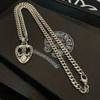 Silver-tone necklace chain with Chrome Hearts heart pendant, close-up on a case
