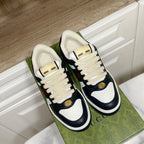 Gucci unisex sneakers with cream laces, navy leather, and green/red web stripe detail