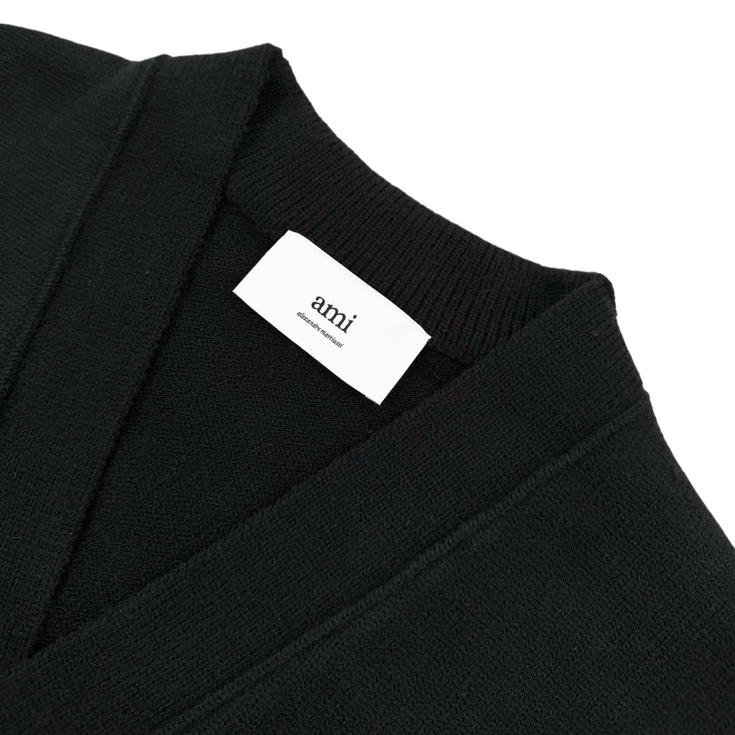 Amiri knit cardigan neckline with white 'amiri' label