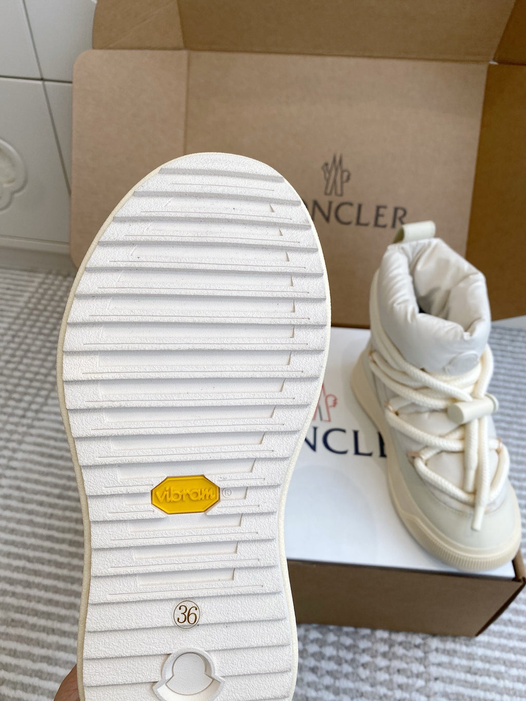Moncler white sneaker outsole with tread and size marking, with padded upper shown