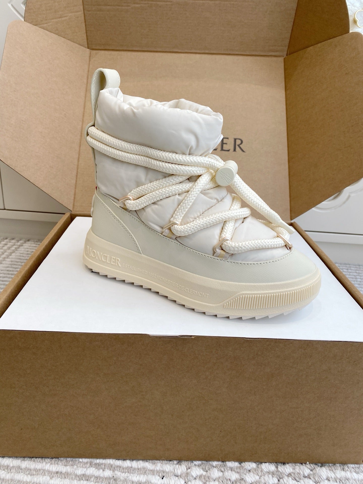 White Moncler high-top sneaker with lace-up closure and side panel detail