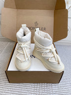 Pair of white Moncler high-top sneakers with lace-up fronts and padded ankle cuffs