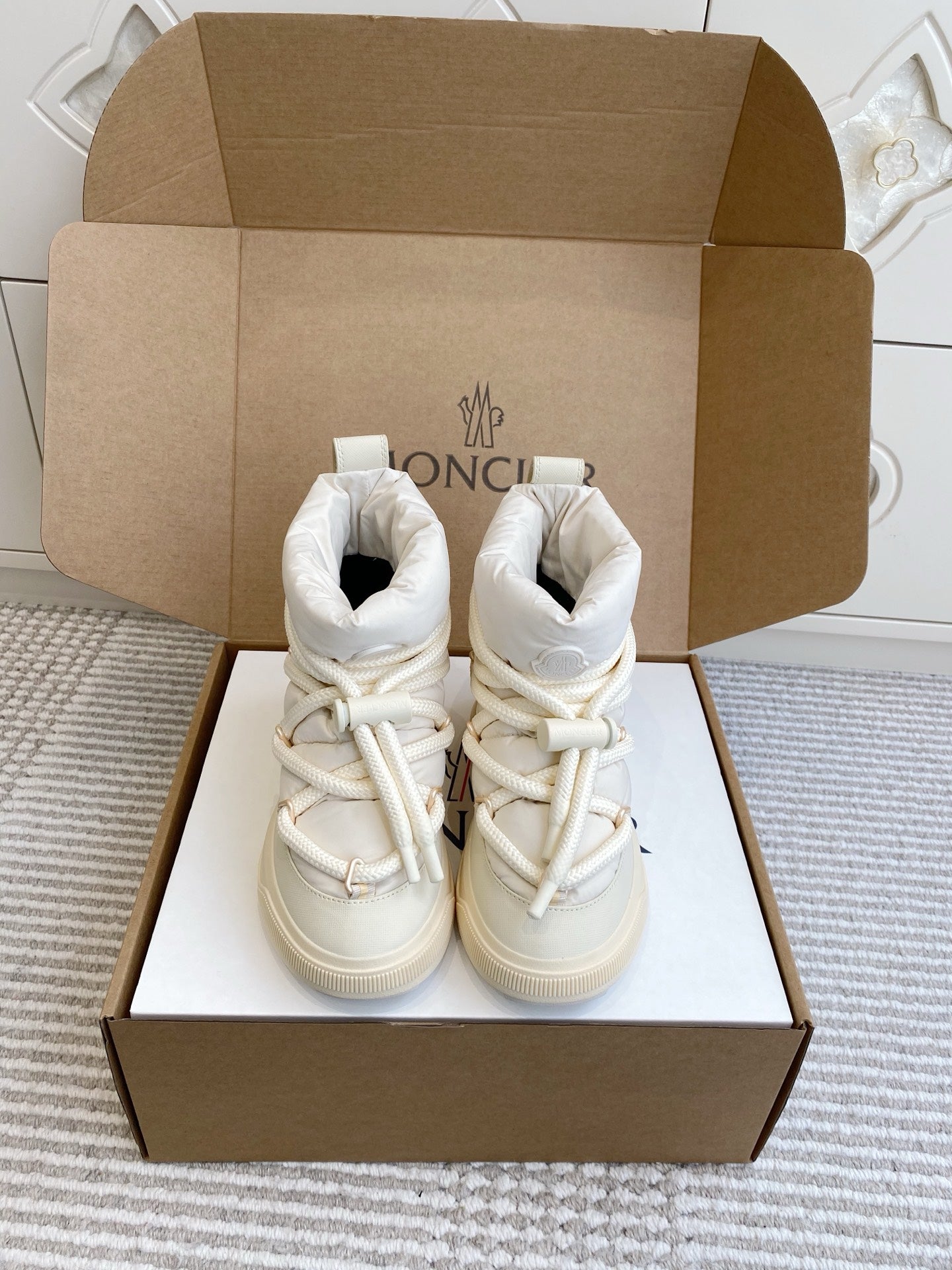 White Moncler high-top sneakers with lace-up closure and padded tongue, in box