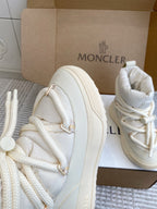 White Moncler high-top sneaker side view with lace-up stitching and thick sole