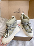 Moncler high-top sneakers, angled view, sage green panels with gray laces and white sole