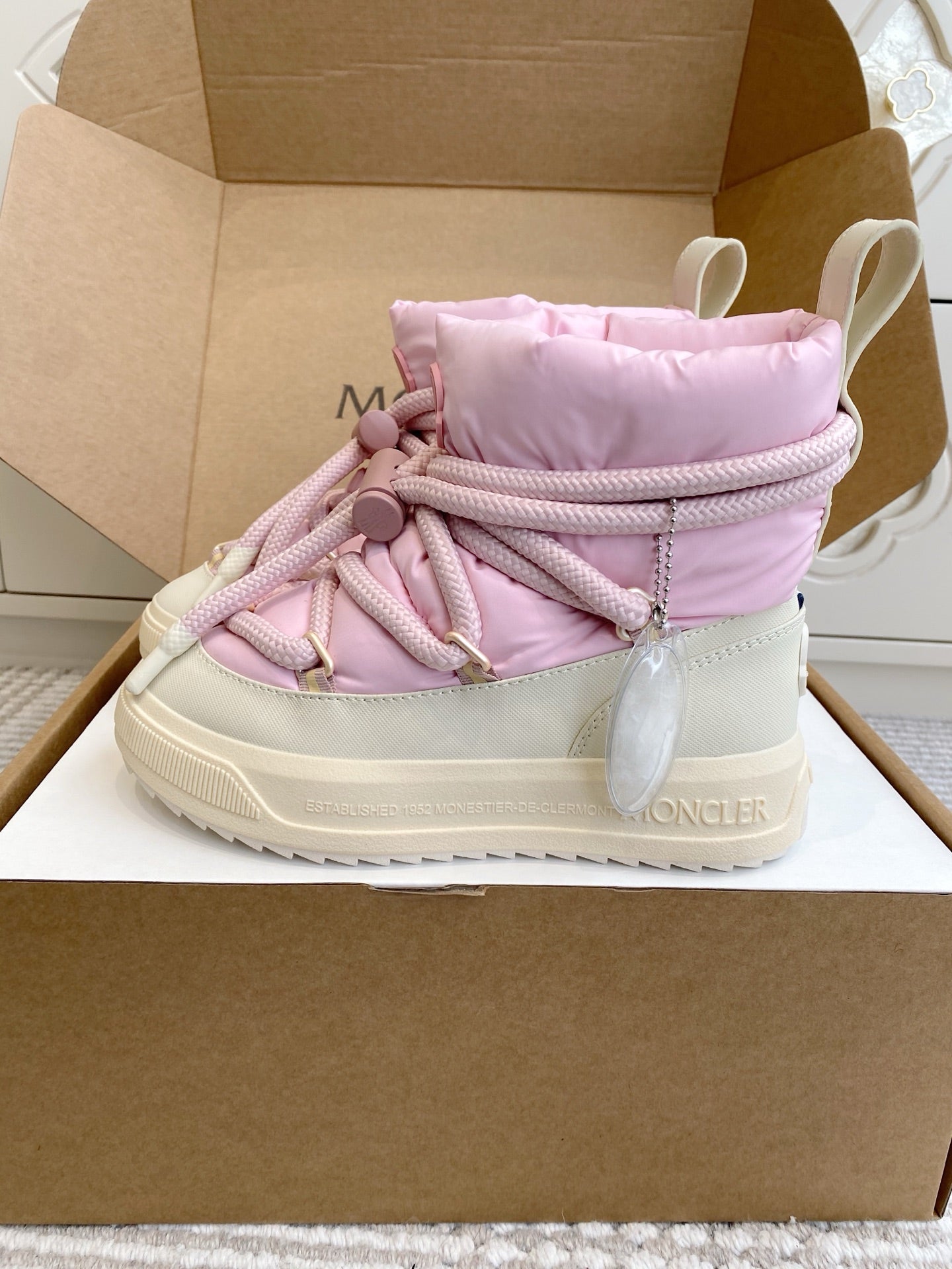 Moncler pink puffer sneakers, side profile with quilted collar and rope laces
