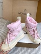 Moncler pink puffer sneakers held up, showing lace-up fronts and thick white soles