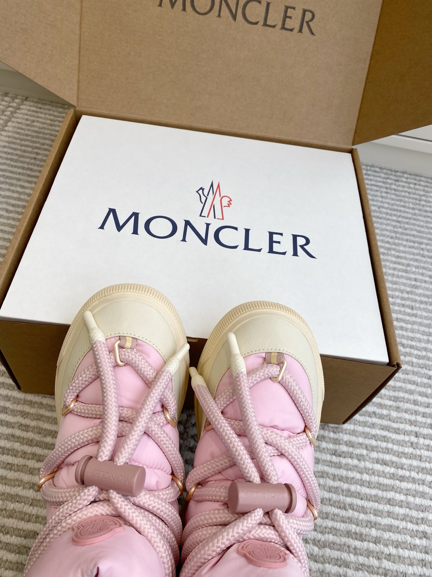Moncler pink puffer sneakers with lace details and Moncler logo on the tongue