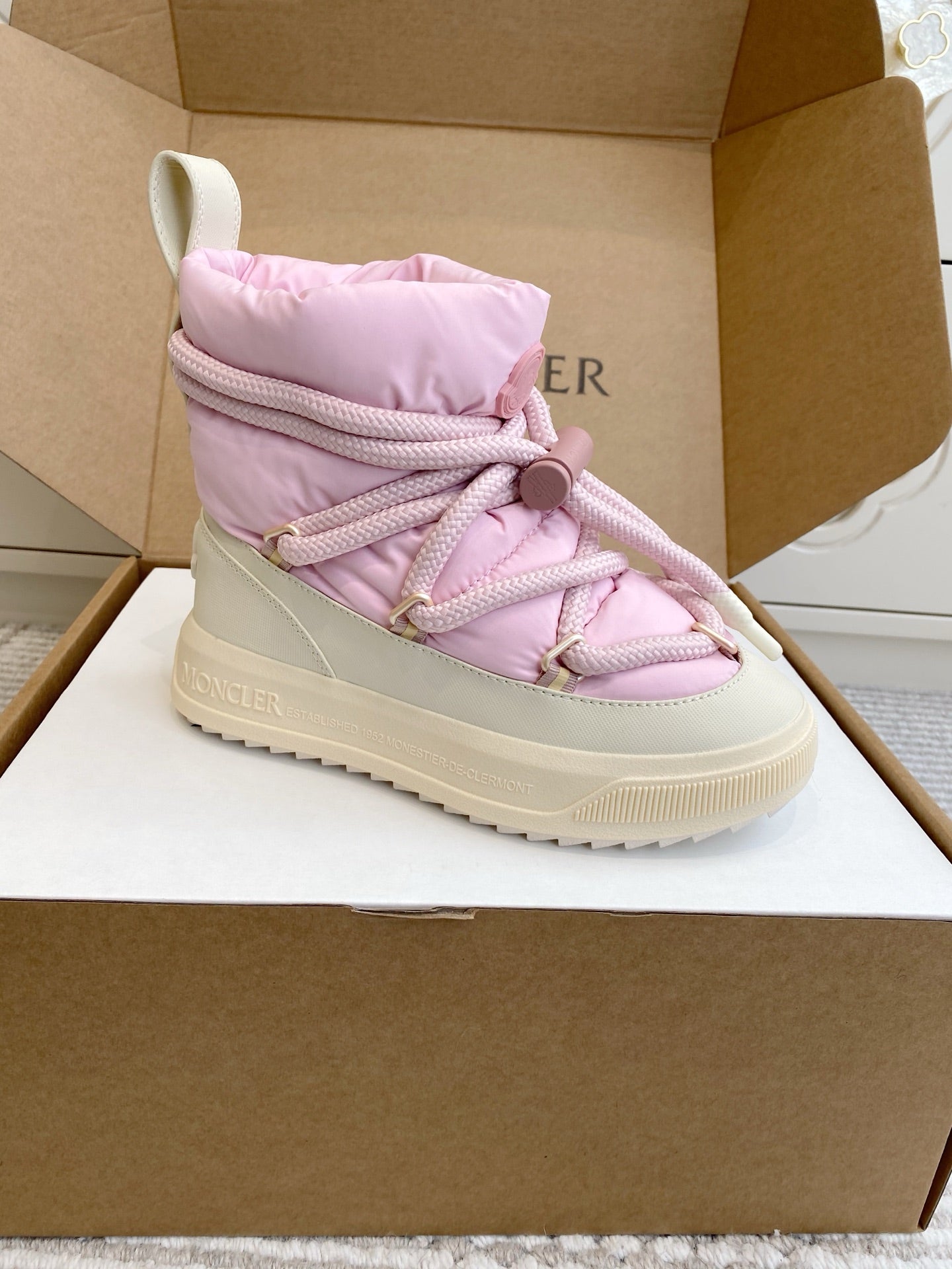 Moncler pink puffer sneaker with quilted upper, lace-up front, and rubber sole