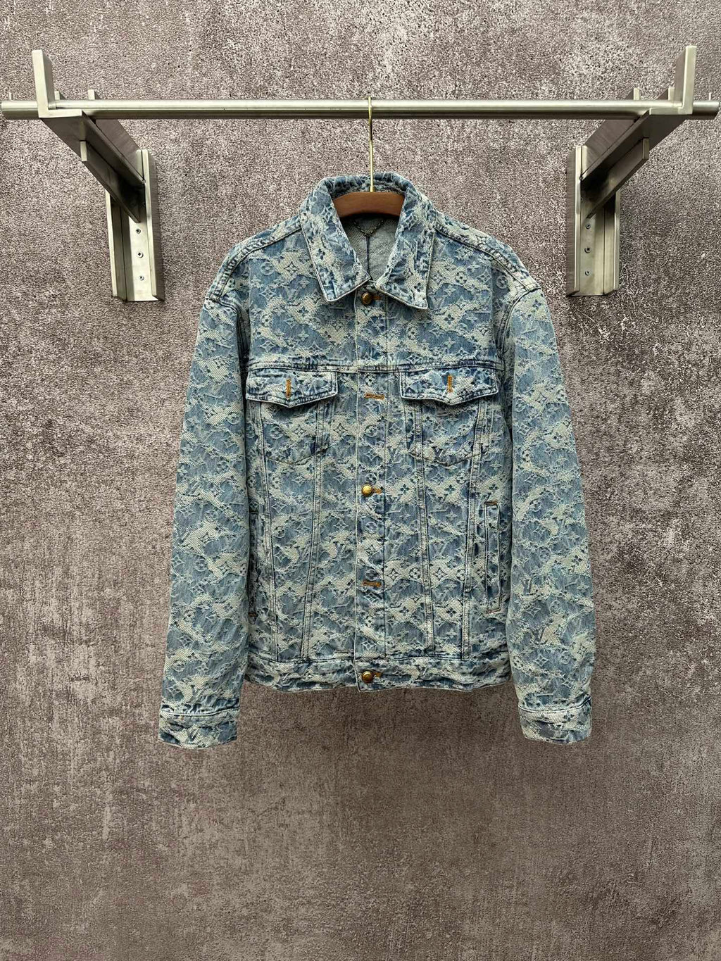 Blue denim jacket with all-over monogram pattern, button front, and flap chest pockets