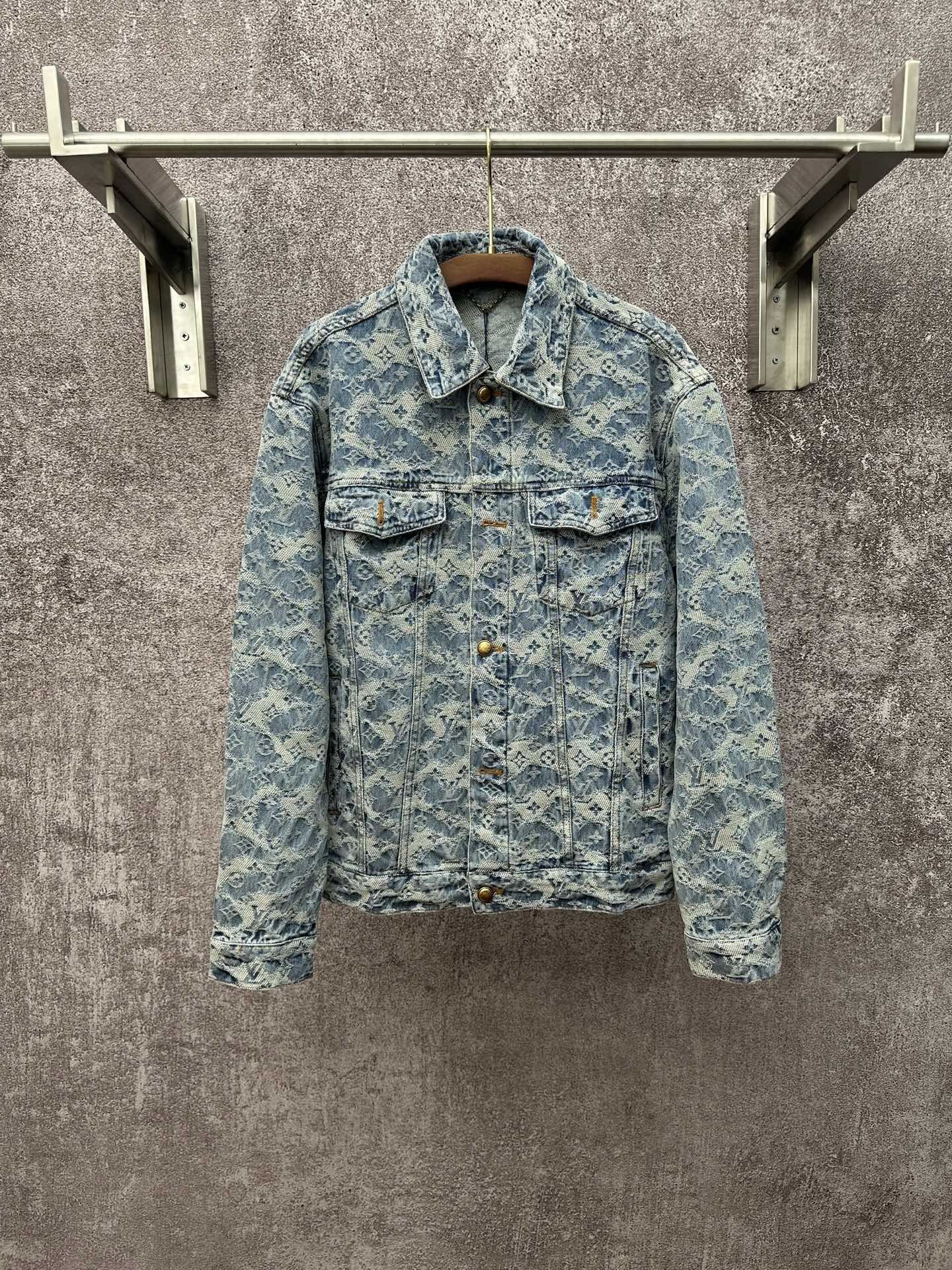 Blue denim jacket with all-over monogram pattern, button front, and flap chest pockets